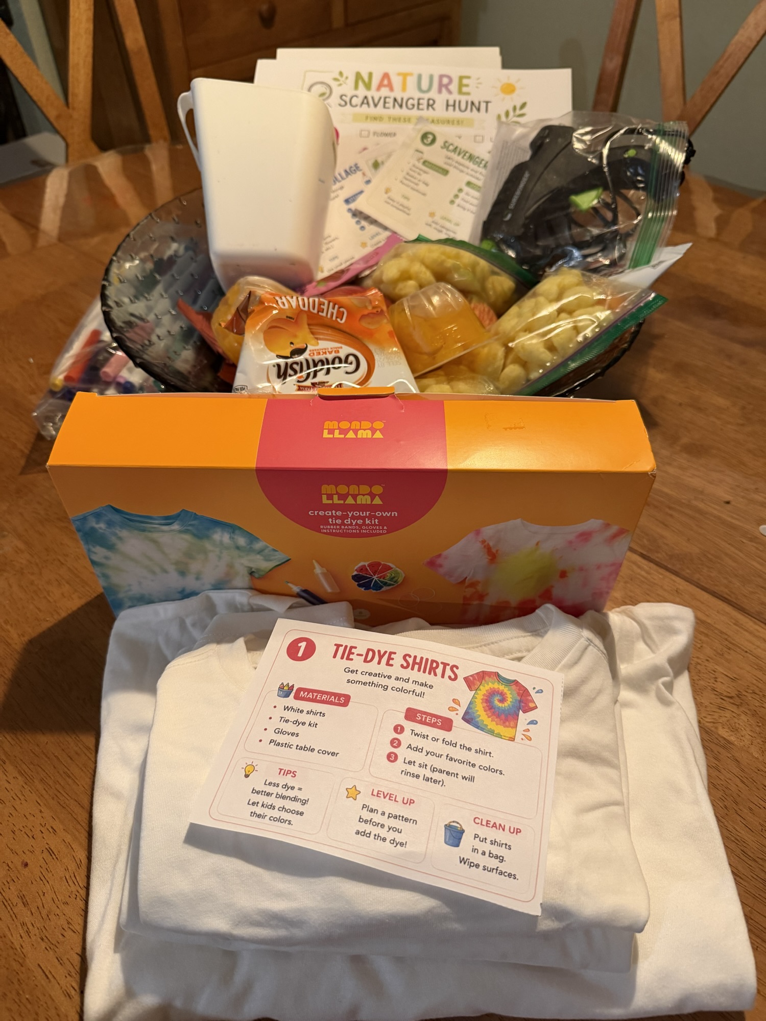 Photo of a camp day prepped with tie-dye shirt kits, a nature scavenger hunt, and some snacks!